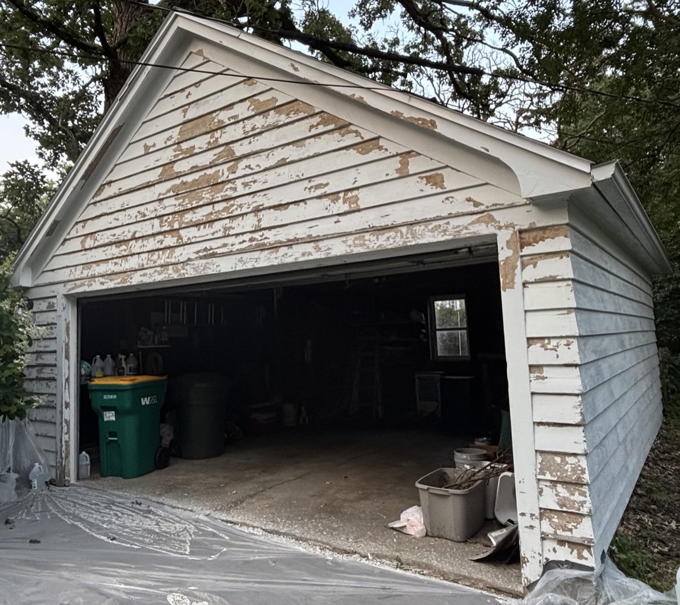 Garage during prep work, paint scraped off and drop cloths down